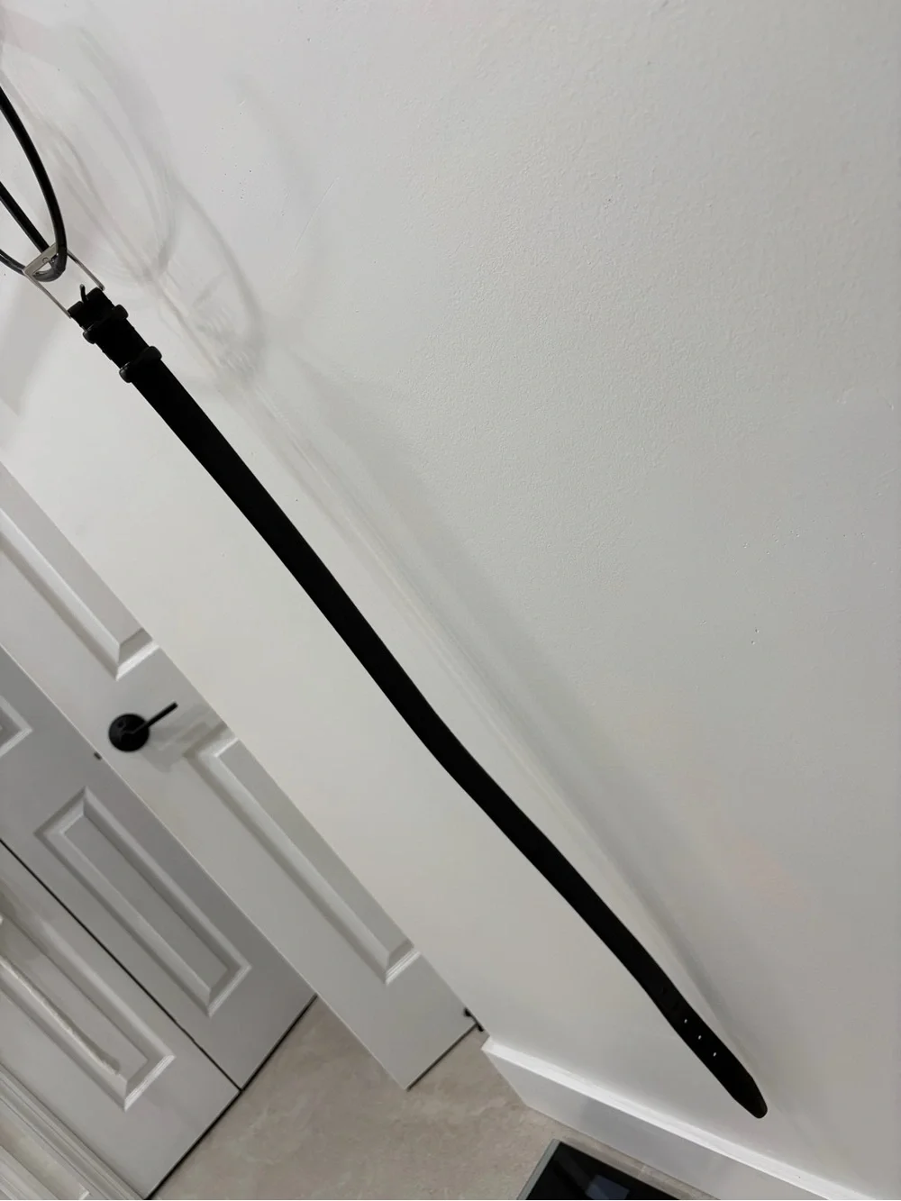 Men’s black leather belt with silver buckle